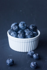 blueberry in a bowl on a black background