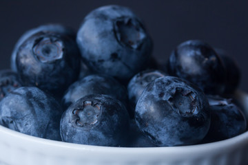blueberry in a bowl on a black background