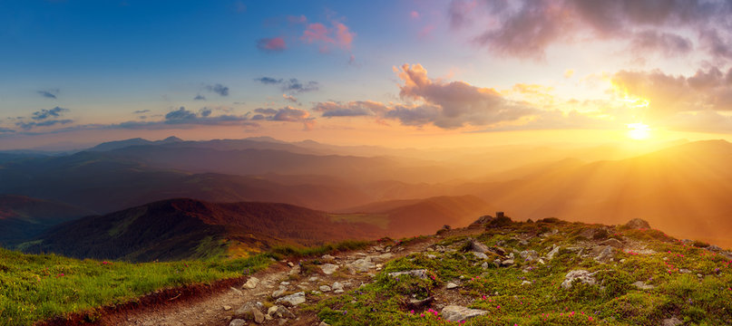 Amazing mountain landscape with colorful vivid sunset on the cloudy sky, natural outdoor travel background. Beauty world. Panoramic view.