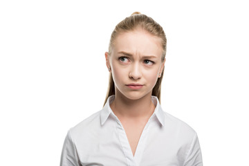 head and shoulders shot of doubtful caucasian teenage girl isolated on white