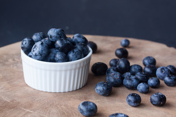 Blueberry in a bowl on a wood background