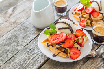 Waffles with strawberry, ice cream and chocolate