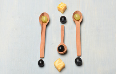 Wooden spoons with grapes as art and healthy food concept