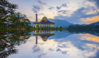 Mirror reflection of beautiful mosque during sunrise.
