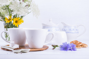 Medicinal plant chicory, Diet drink chicory in a cup with milk for breakfast on a white table.