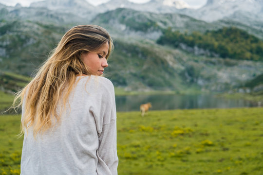 Woman Relaxing In Mountain Meadow