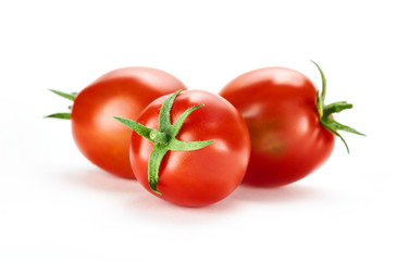 Three fresh ripe red tomatoes isolated on a white background