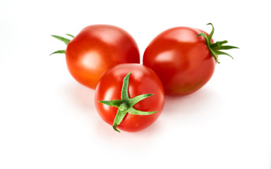 Three fresh ripe red tomatoes isolated on a white background