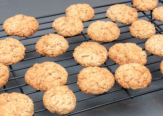 Freshly baked oatmeal cookies cooling on rack