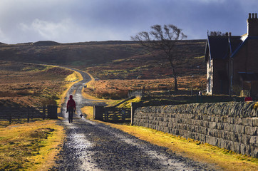 A hiker exploring the English Countryside, Muggleswick Common near Edmundbyers, England UK.