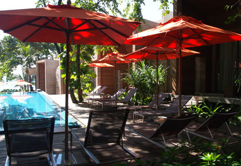 Rayong - 22 November 2011 - Relaxing rattan chairs besides swimming pool ,Thailand