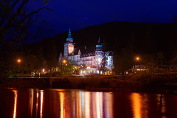 Fototapeta na wymiar Lillafured palace in Miskolc, Hungary in the night. Lake Hamori in foreground with reflections. Travel outdoor landmark background