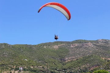 Paraglider landing in a special zone at Cleopatra Beach in Alanya (Turkey).