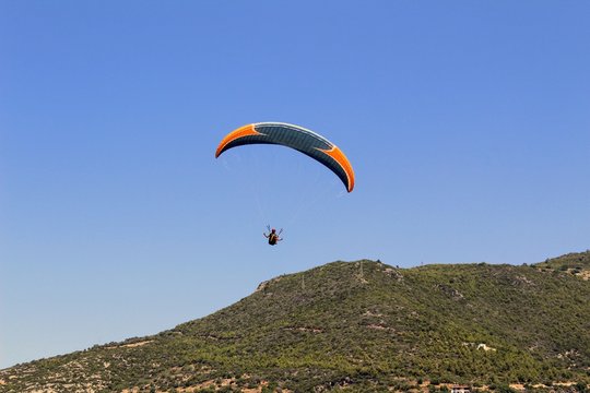 Paraglider landing in a special zone at Cleopatra Beach in Alanya (Turkey).