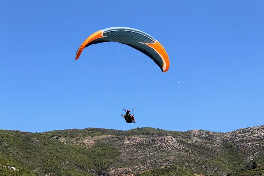 Paraglider landing in a special zone at Cleopatra Beach in Alanya (Turkey).