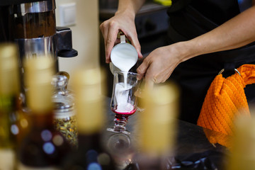 pouring coffee in glass to make macchiato coffee