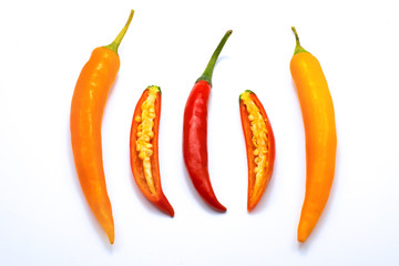 Close up sliced red and orange chilli pepper white isolated