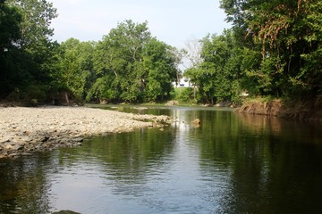 The bend in the flowing river at the park.