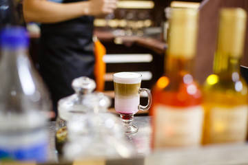 Glass of coffee cocktail on on the wooden table.