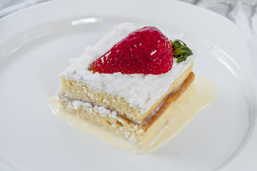 Piece of Vanilla cake With Strawberry In Plate