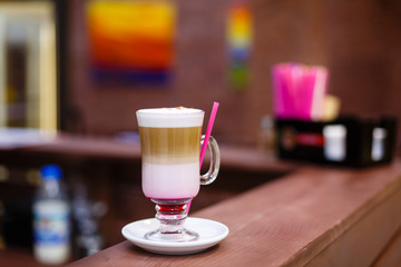 Glass of coffee cocktail on on the wooden table.