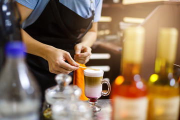 Barista prepares latte macchiato