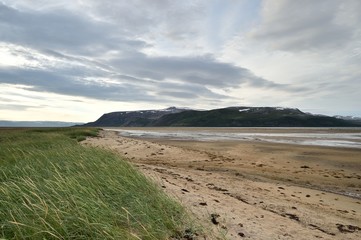 Sandy coast with mountain in Tanamunningen Nature Reserve in Norther Norway