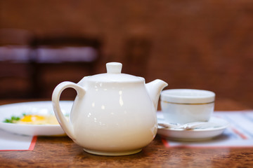 Cup of tea with teapot