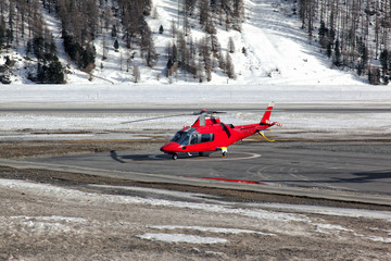 A red helicopter ready to take off