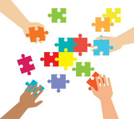 Hands and pieces of puzzles on a white background. Business and construction. Command and merge.