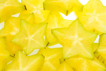 Fototapeta premium Star fruit on white isolated background translucent delicious natural sweet shape starfruit food texture detail macro close up carambola graphic pattern