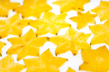 Fototapeta premium Star fruit on white isolated background translucent delicious natural sweet shape starfruit food texture detail macro close up carambola graphic pattern