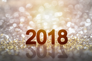 2018 for ney year on glitter vintage lights background. gold, silver and black. de-focused.