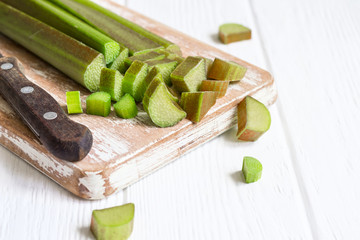 Fresh rhubarb stems on a cutting board