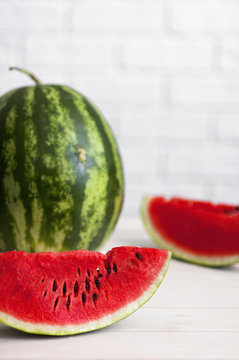 Watermelon on a light rustic wooden background.