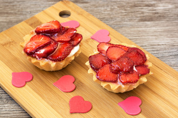 Cake with fresh strawberries and red heart.A delicious dessert