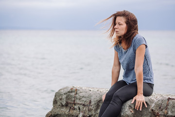 Woman alone and depressed at seaside