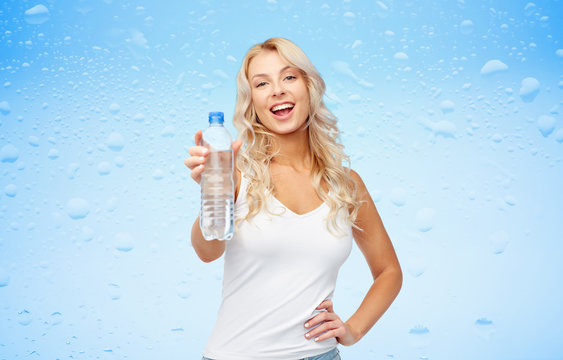 happy beautiful young woman with bottle of water
