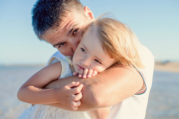 Happy father and daugther with isolated on the sea background. Close up