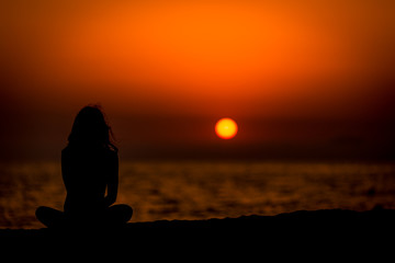 Girl in sunset meditation