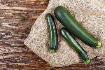 Fresh zucchini on a wooden table.Space for text.
