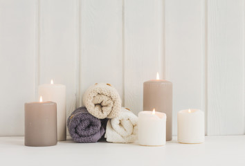 Fototapeta na wymiar Spa composition. Spa candles. towels on rustic white wooden background.