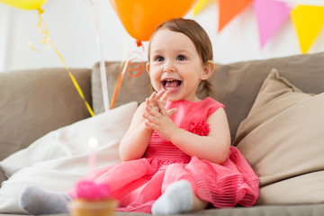 happy baby girl on birthday party at home