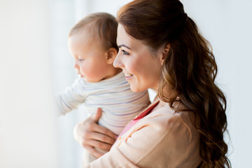 happy young mother with little baby at home