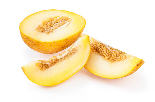 Slices of ripe yellow melon with seeds, on white background