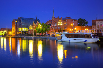 Architecture of Bydgoszcz city with reflection in Brda river at night, Poland
