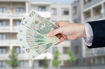 Real estate agent holds Polish money