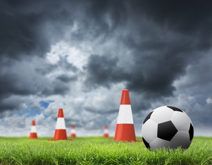 Soccer ball with orange cones on field