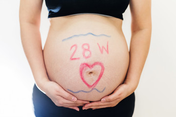 Pregnant belly painted 28 weeks and heart