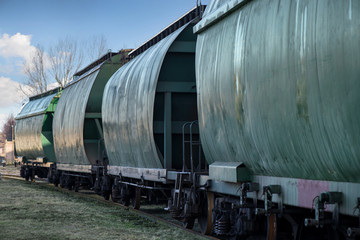 City junction railway yard on which sorting of freight railway trains takes place. Train wagons in row on the rails at railway station. Freight train. Cargo waiting to be exported world wide by ship